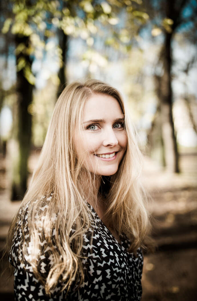 PhD candidate profile picture, smiling, clothed in black and white blouse