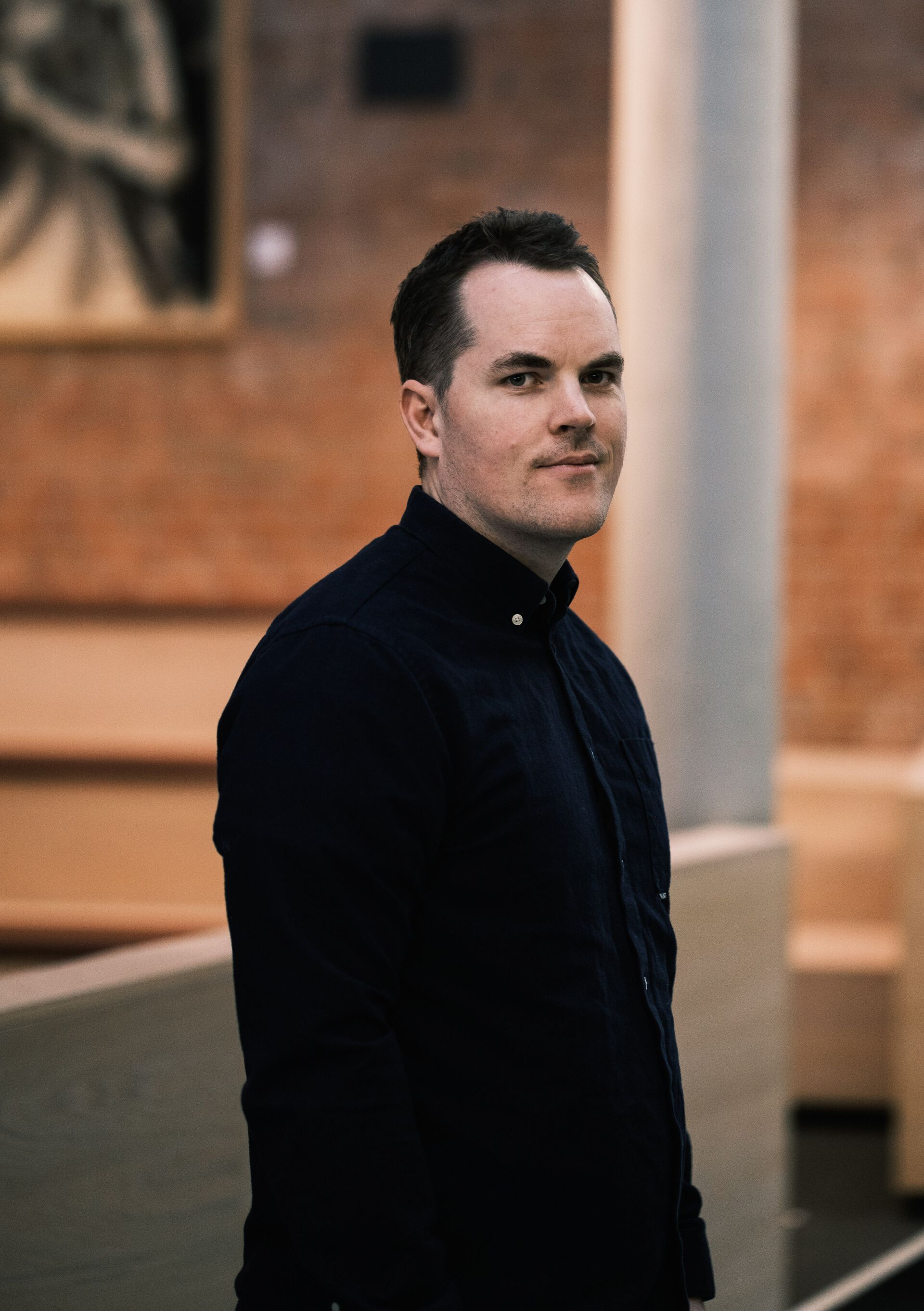 PhD candidate profile picture, smiling, clothed in black