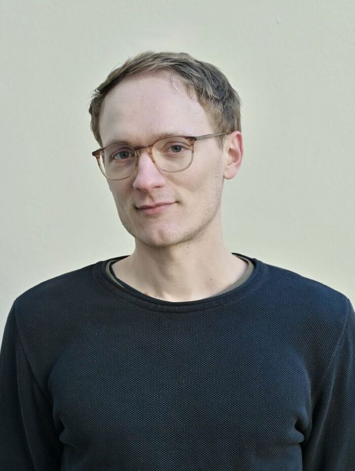 A profile picture of the candidate clothed in a navy sweater