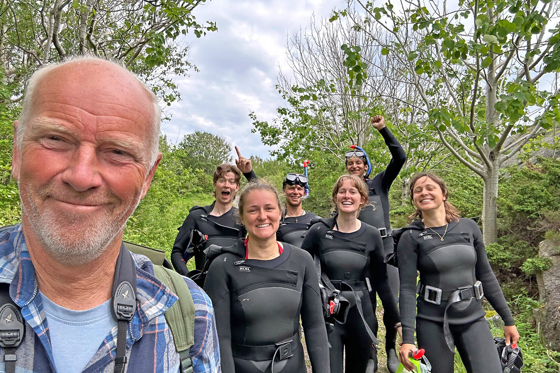 Image may contain: Wetsuit, Smile, Recreation, Personal protective equipment, Diving equipment.