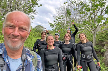 Image may contain: Wetsuit, Smile, Recreation, Personal protective equipment, Diving equipment.