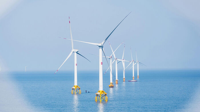 The picture shows an offshore windfarm.