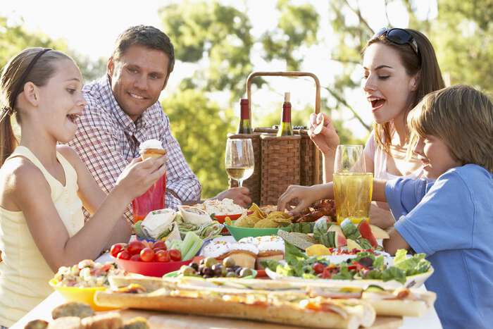 Stock photo of a family enjoying a meal while the parents are consuming alcohol