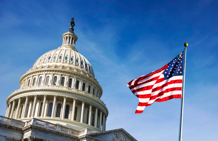 United States Capitol med det amerikanske flagget i forgrunnen