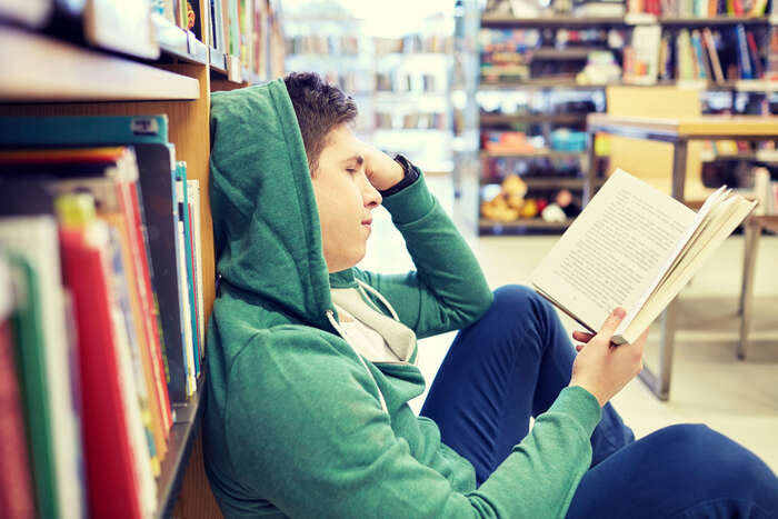 A young boy sitting and reading