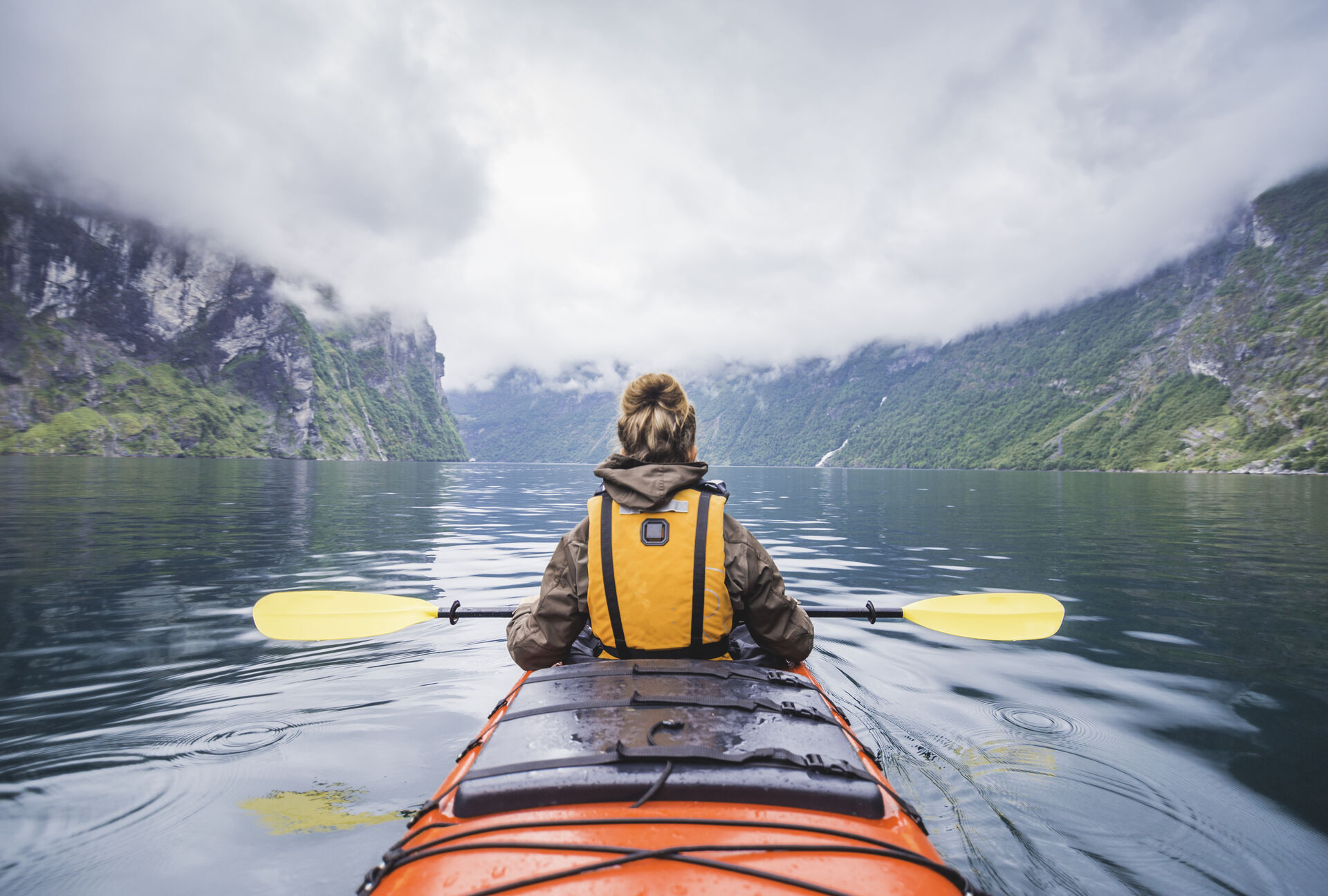 Woman in a boat on a fjord