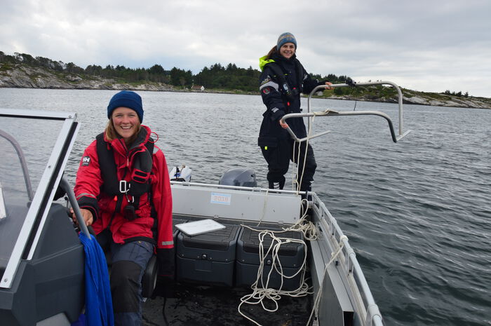 Photo of researchers on a small boat