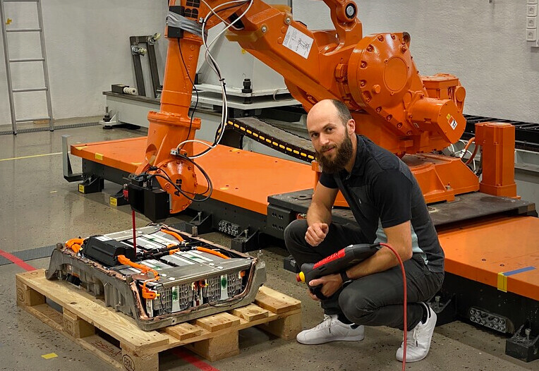 Image may contain: Motor vehicle, Workwear, Orange, Engineering, Automotive tire.