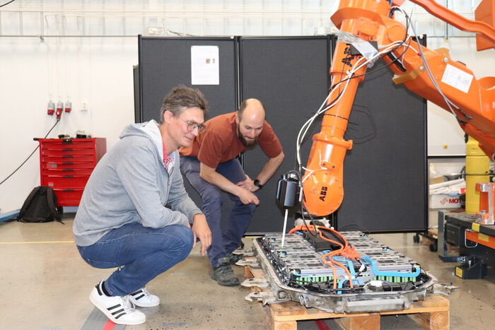 Photo shows researchers check the robot gripper.