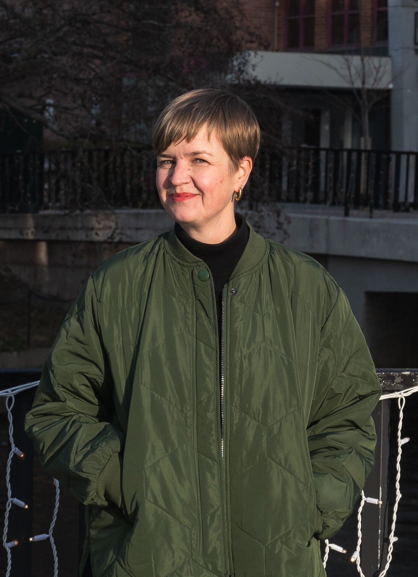 A profile picture of the candidate clothed in a green jacket