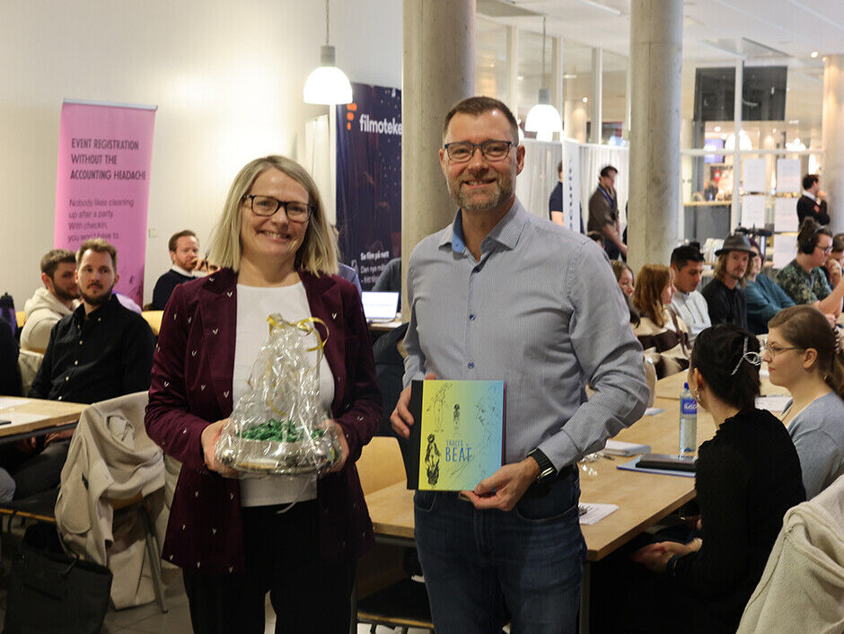 Rektor Sunniva Whittaker og konsernsjef Hans Georg Høgevold-Garstad  poserer for kamerra med en en forsmaling i bakgrunnen. 