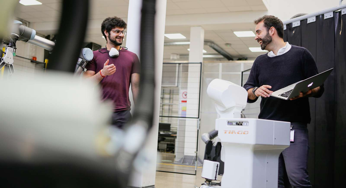 Two people in a lab talking together