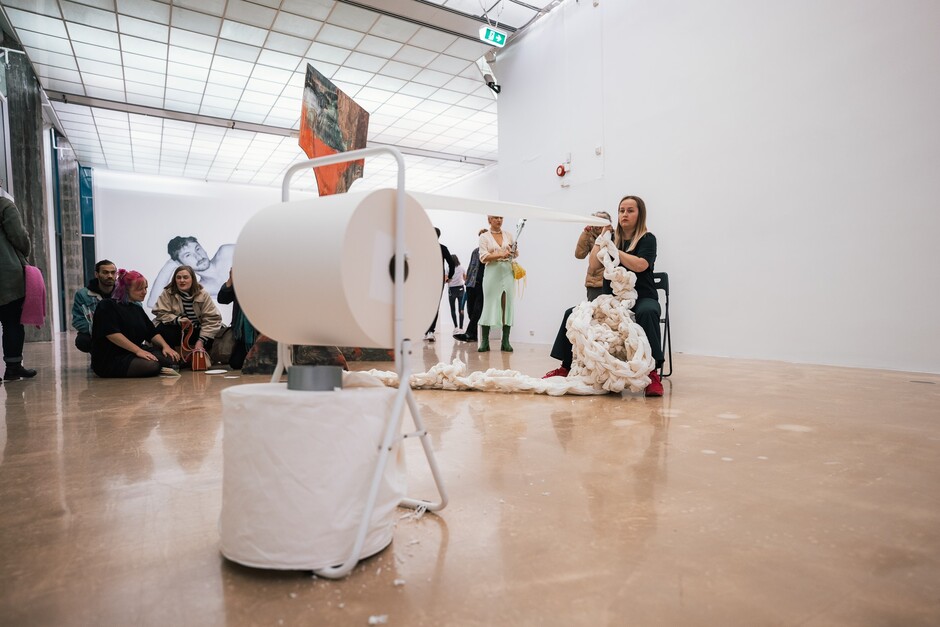 Stor rull med papir som blir rullet ut i hvit kunsthall