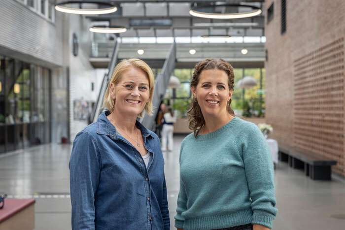 Photo of two careers advisers standing side by side in Vrimlehallen