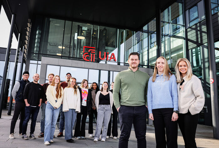 En gjeng studenter står foran UiA Grimstads hovedinngang