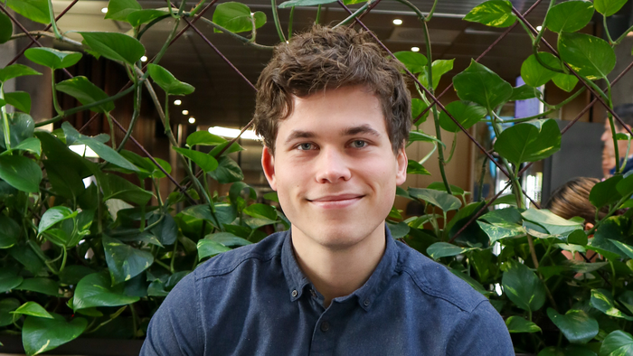 Benjamin ser inn i kamera og smiler. 
