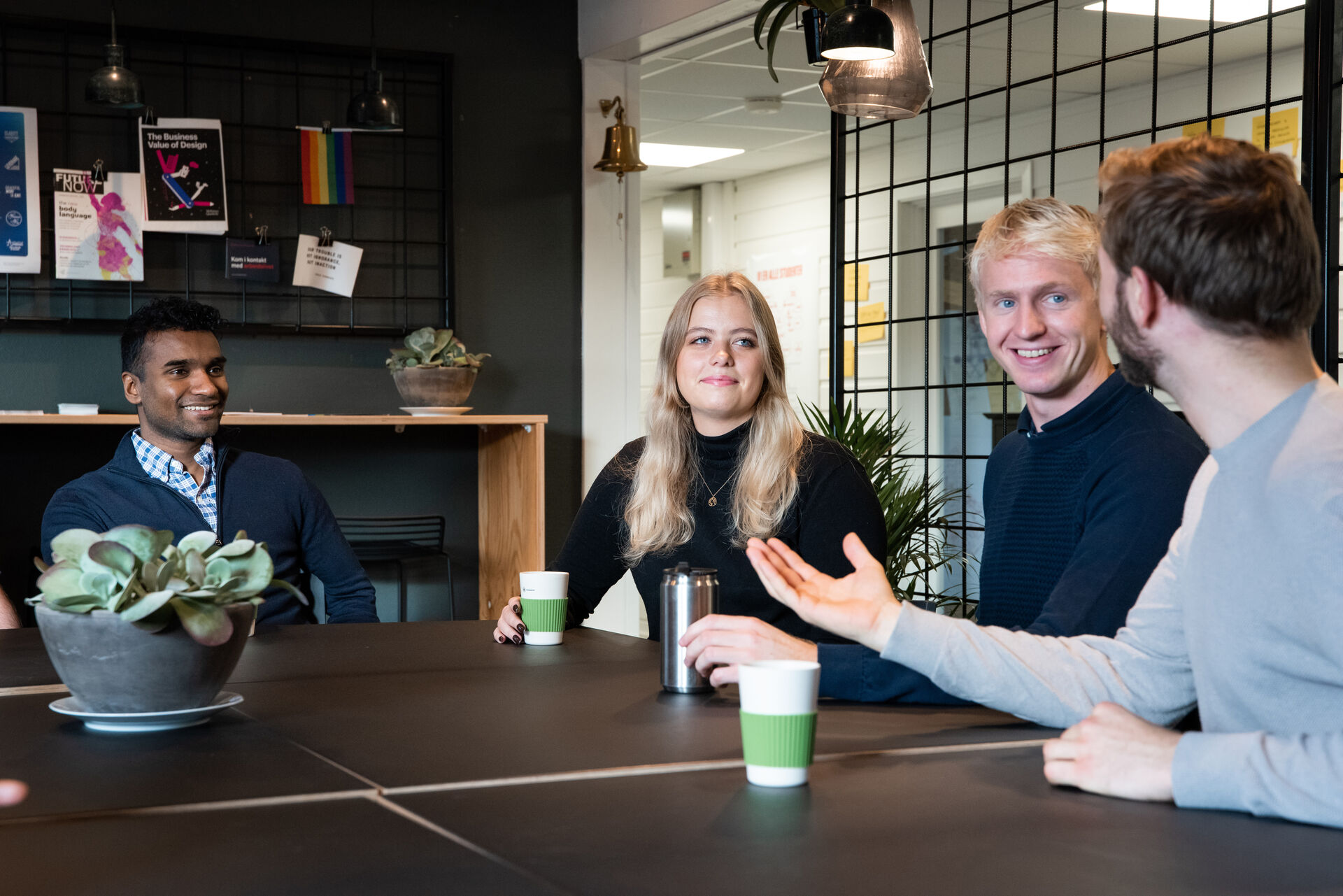 Photo of a group of students sitting around a table discussing